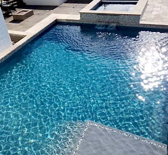 Kid with Broncos hat enjoying pool